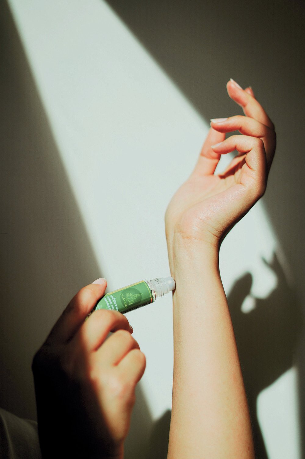 Chayada Herbal Oil Roller being applied on a wrist